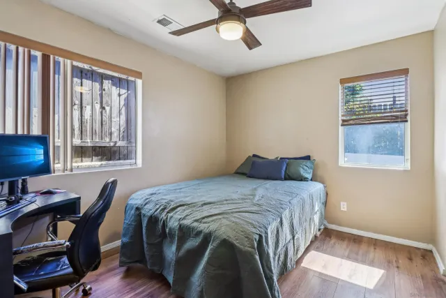 a bed sitting in a bedroom next to a window