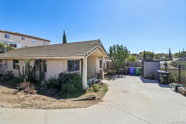 a view of a house with potted plants and more windows