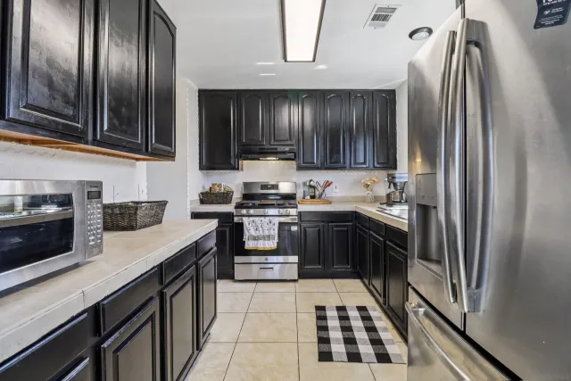 a kitchen with granite countertop stainless steel appliances and wooden cabinets