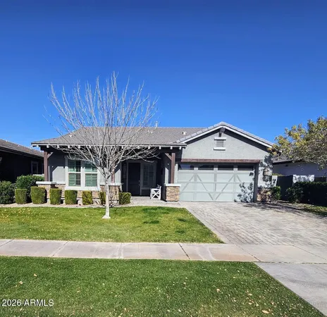 a view of a house with a big yard and large trees