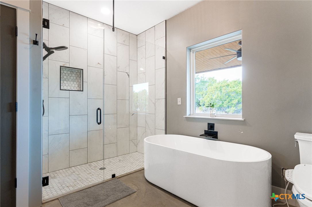 18248 Crows Ranch Road Salado, TX 76571 - Photo 19 of 48 a bathroom with a bathtub a shower a toilet and a sink