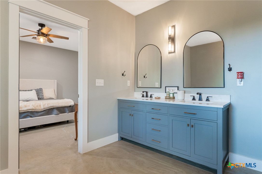 18248 Crows Ranch Road Salado, TX 76571 - Photo 20 of 48 a en suite bathroom with 2 sink and a mirror