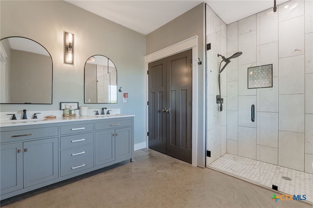 18248 Crows Ranch Road Salado, TX 76571 - Photo 21 of 48 a spacious bathroom with double sink and a mirror