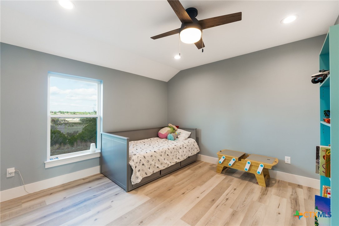 18248 Crows Ranch Road Salado, TX 76571 - Photo 25 of 48 a bedroom with a bed and wooden floor