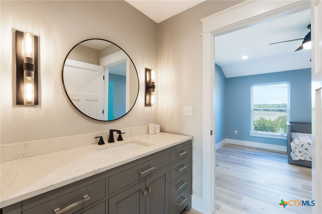 18248 Crows Ranch Road Salado, TX 76571 - Photo 29 of 48 a en suite bathroom with a sink and a mirror