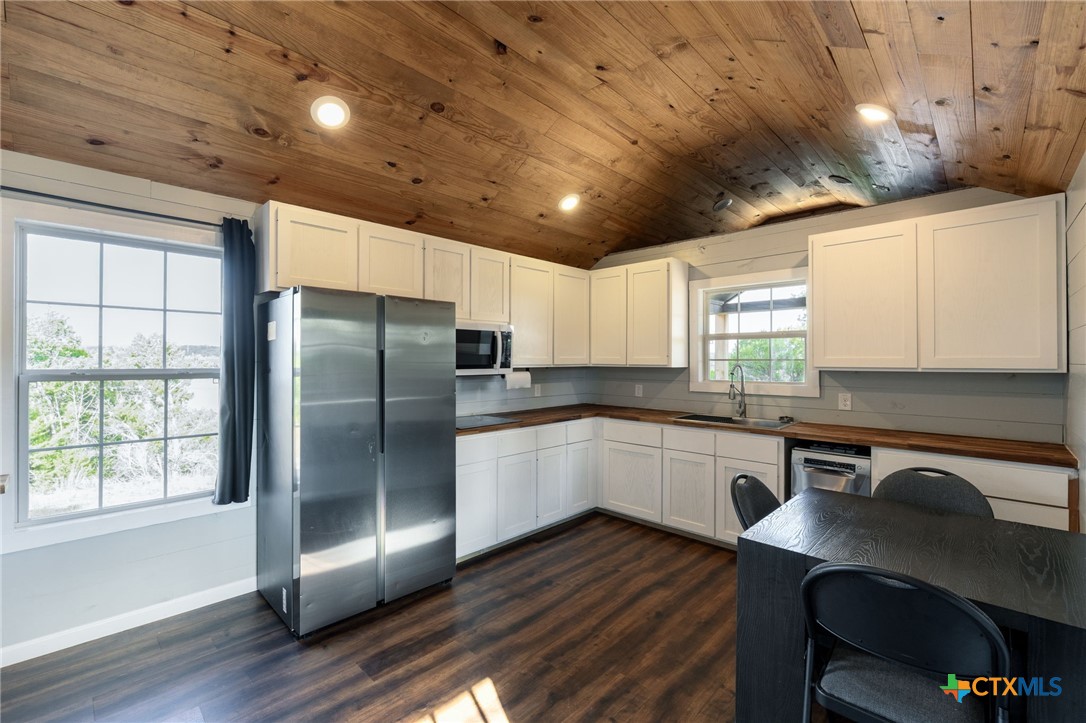 18248 Crows Ranch Road Salado, TX 76571 - Photo 38 of 48 a kitchen with stainless steel appliances granite countertop a sink refrigerator and cabinets