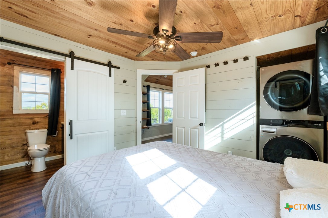 18248 Crows Ranch Road Salado, TX 76571 - Photo 41 of 48 a bedroom with a bed and a large window