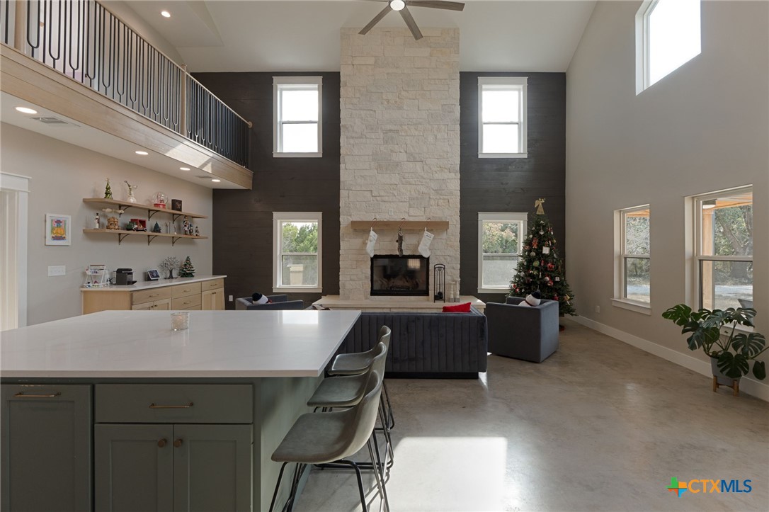 18248 Crows Ranch Road Salado, TX 76571 - Photo 8 of 48 a living room with furniture a flat screen tv and a fireplace