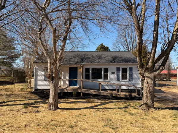 a view of a house with a yard covered in snow