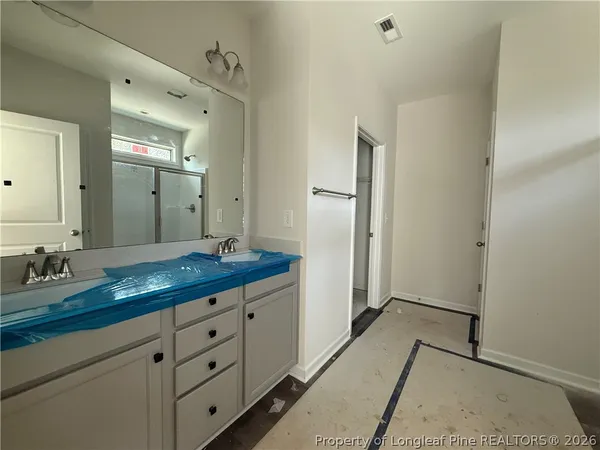 a spacious bathroom with a granite countertop sink mirror and double