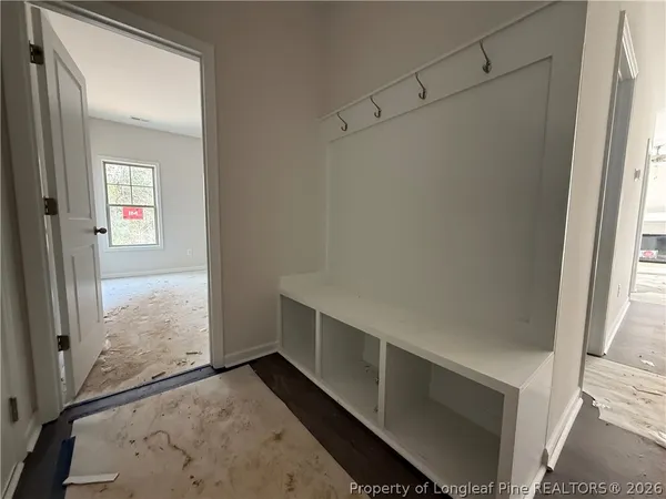 a view of an empty walk in closet and a window