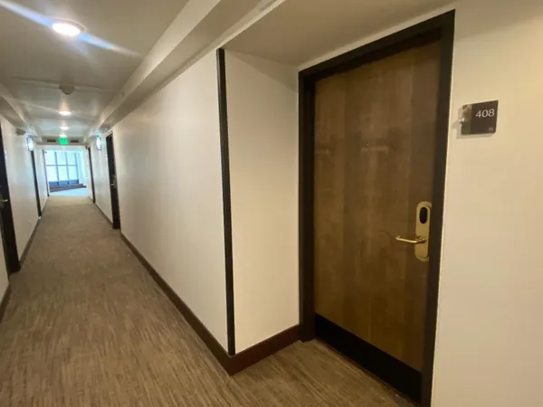 a living room with furniture a flat screen tv and a window