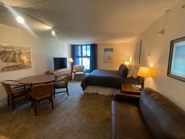 a bathroom with a sink a toilet a mirror and shower