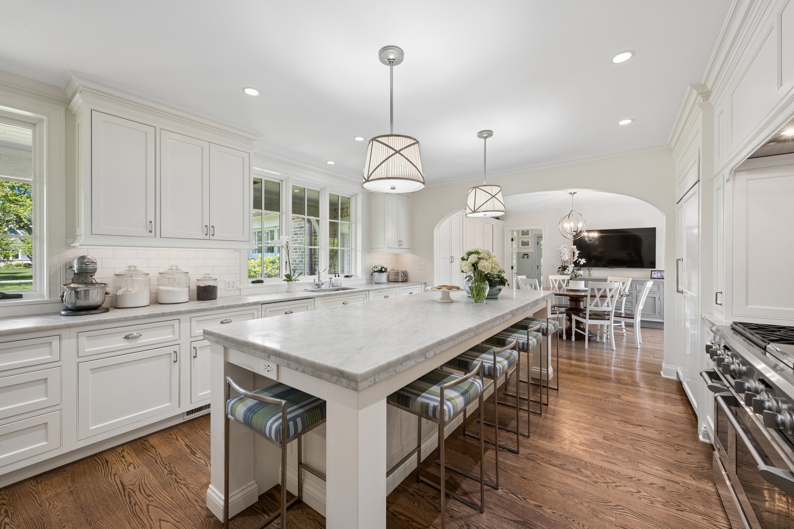 936 Sunset Road Winnetka, IL 60093 - Photo 22 of 50 a kitchen with stainless steel appliances a kitchen island a stove a table and chairs in it