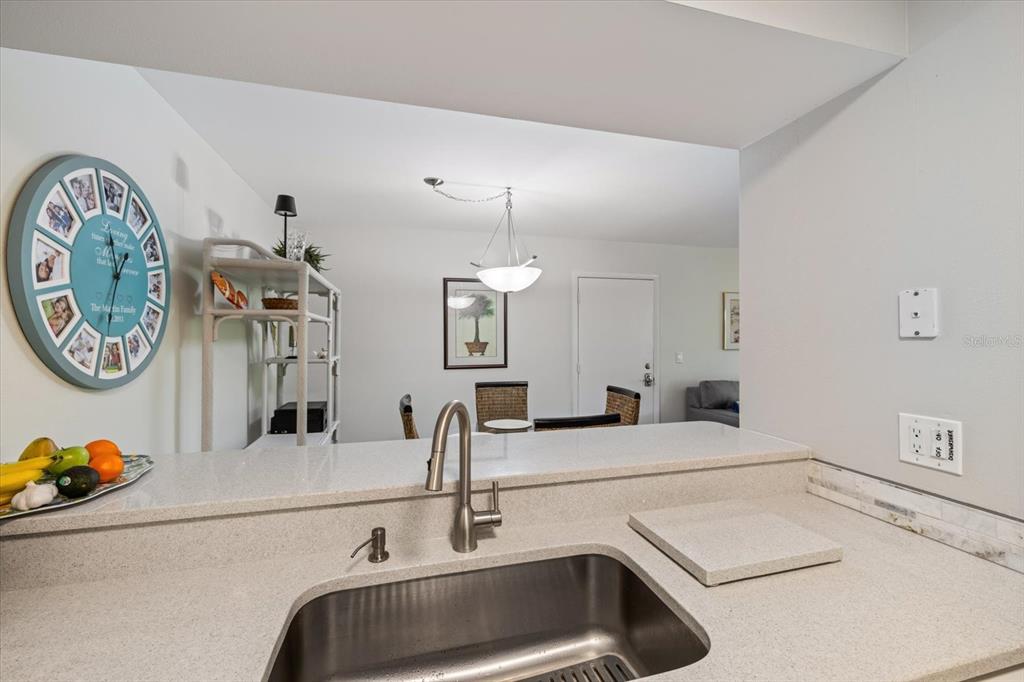 748 White Pine Tree Road, Unit 204 Venice, FL 34285 - Photo 13 of 48 a bathroom with a sink and a stove with mirror
