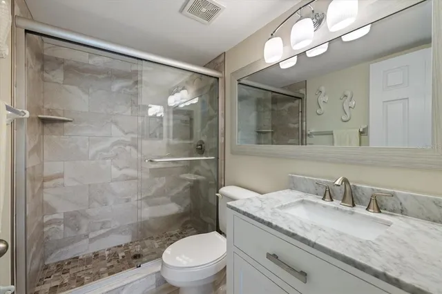 a bathroom with a sink a toilet and shower curtain