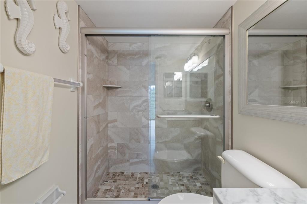 748 White Pine Tree Road, Unit 204 Venice, FL 34285 - Photo 23 of 48 a bathroom with a glass shower door