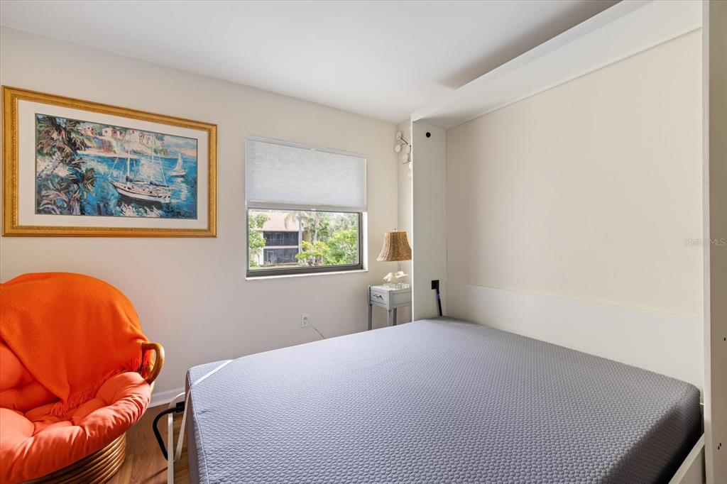 748 White Pine Tree Road, Unit 204 Venice, FL 34285 - Photo 28 of 48 a bedroom with a bed and a window