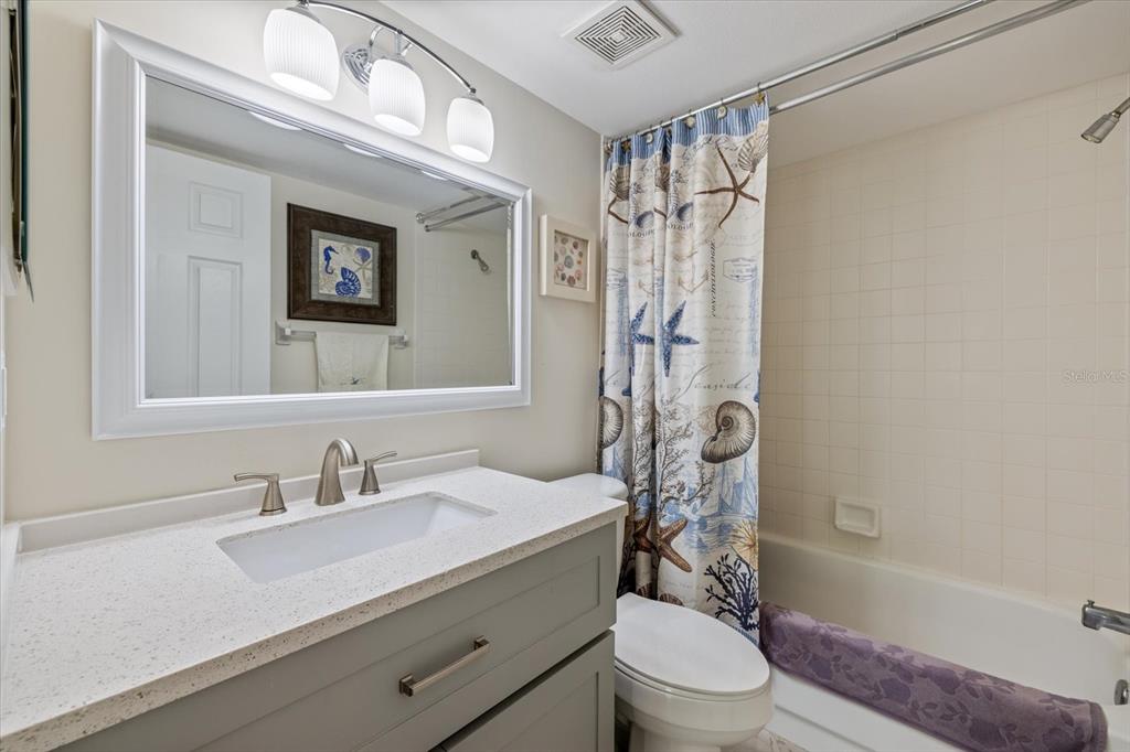 748 White Pine Tree Road, Unit 204 Venice, FL 34285 - Photo 32 of 48 a bathroom with a sink a toilet and shower curtain