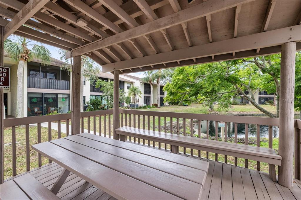 748 White Pine Tree Road, Unit 204 Venice, FL 34285 - Photo 36 of 48 a balcony with wooden floor in outdoor space