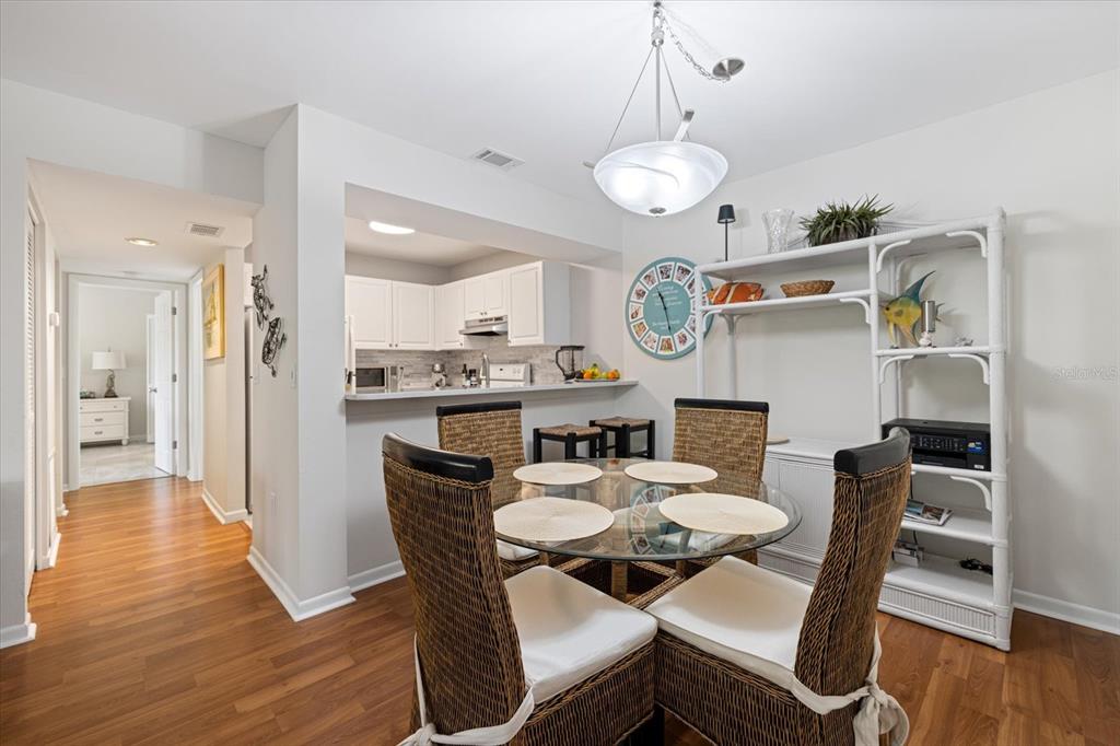 748 White Pine Tree Road, Unit 204 Venice, FL 34285 - Photo 4 of 48 a view of a dining room with furniture and wooden floor