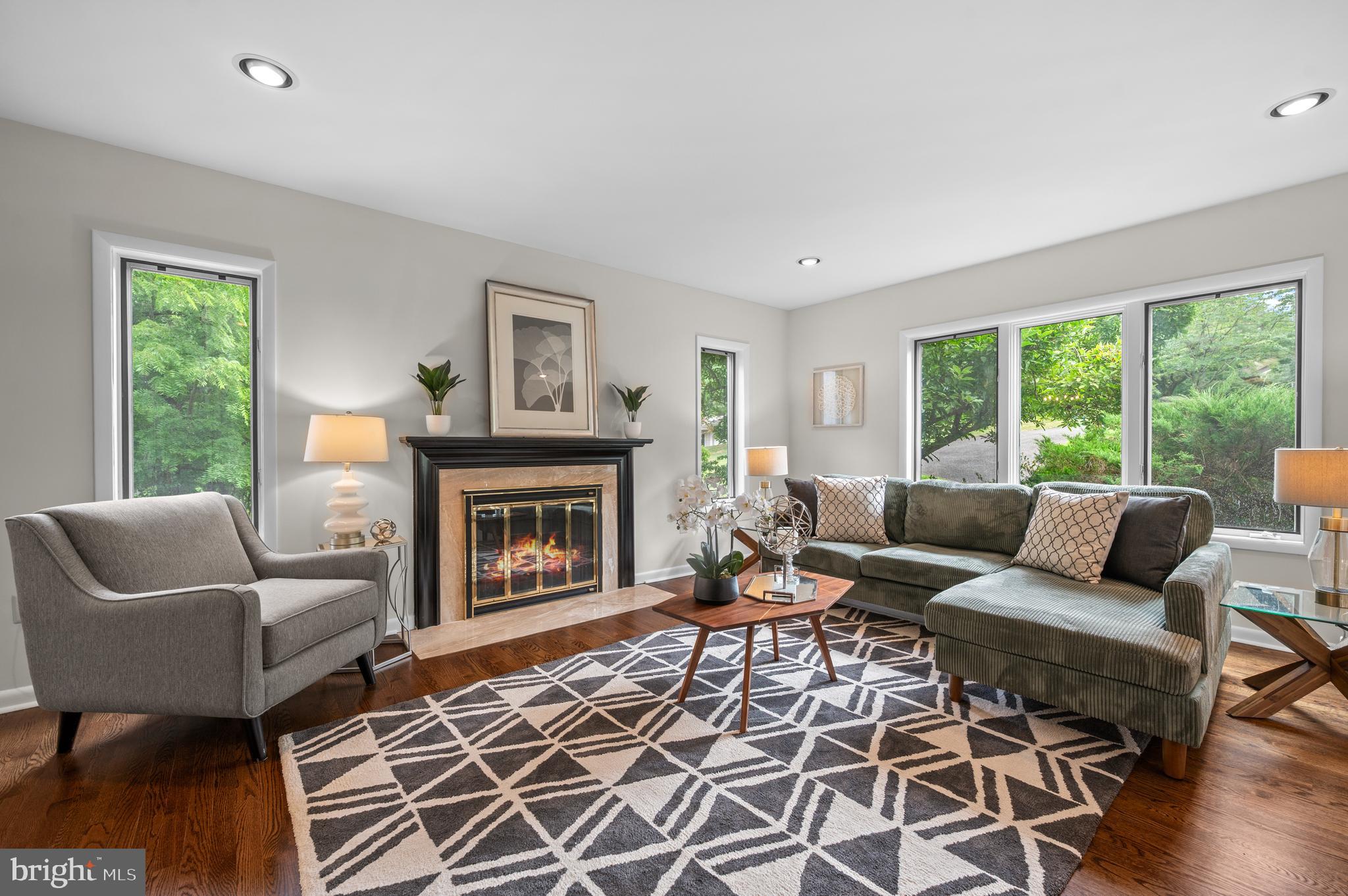 412 Hidden Valley Road Media, PA 19063 - Photo 11 of 51 a living room with furniture a large window and a fireplace
