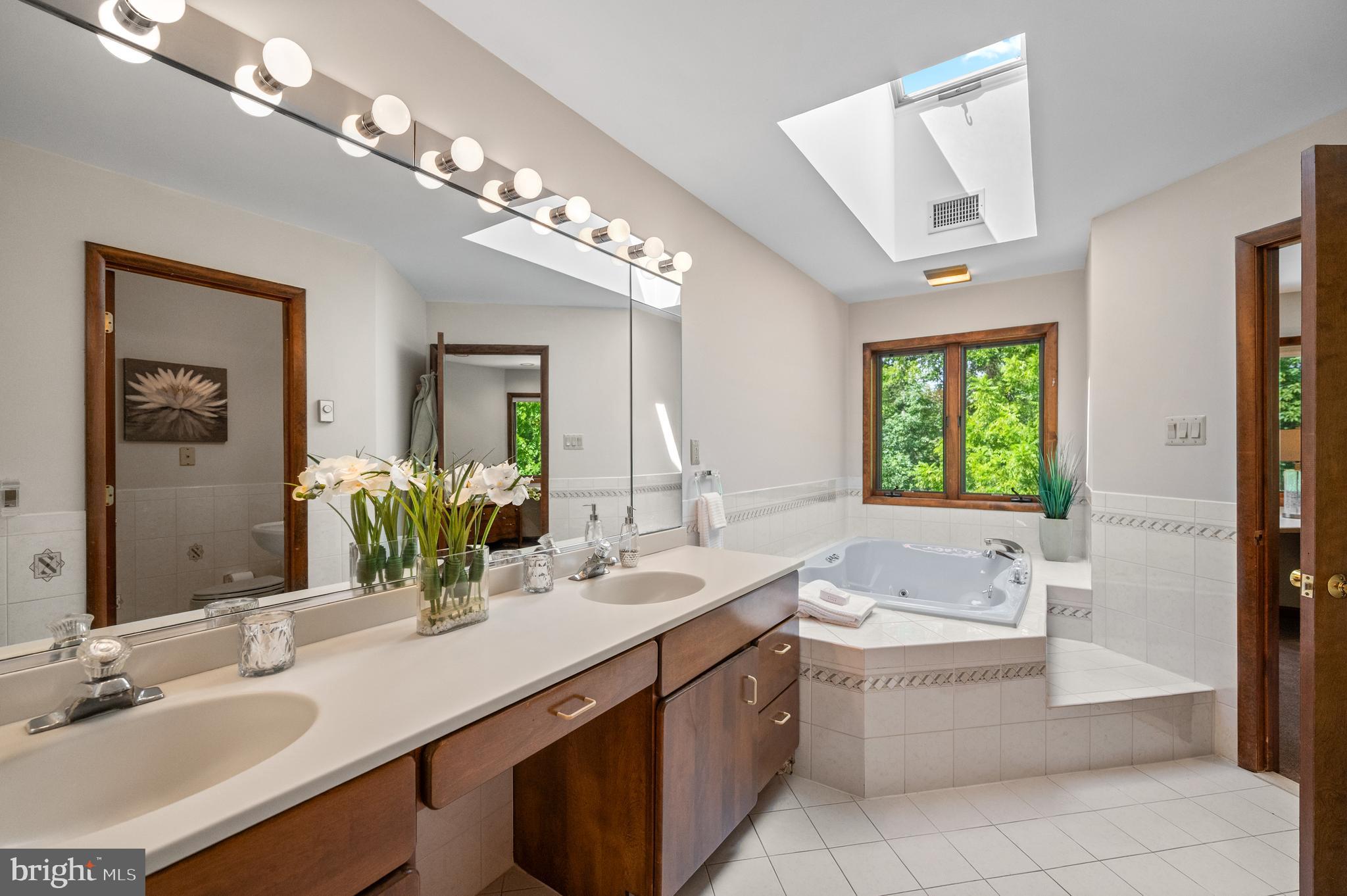 412 Hidden Valley Road Media, PA 19063 - Photo 31 of 51 a bathroom with a granite countertop sink a toilet a mirror and shower
