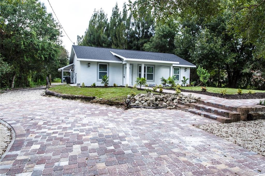 a front view of a house with a garden