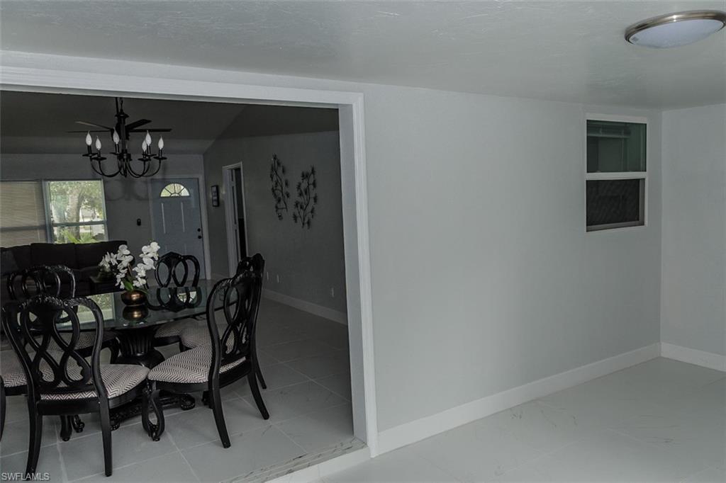 131 22nd Street Northeast Naples, FL 34120 - Photo 13 of 34 a view of a dining room with furniture and chandelier