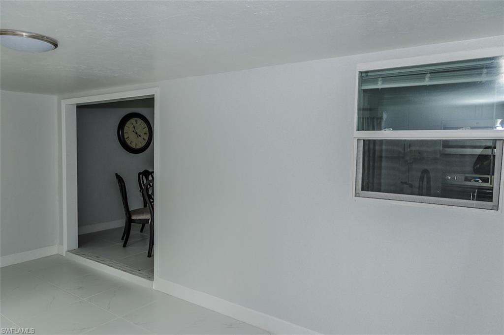 131 22nd Street Northeast Naples, FL 34120 - Photo 14 of 34 a view of a chair and table in a room
