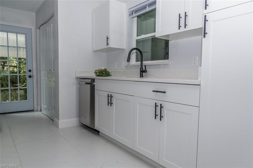131 22nd Street Northeast Naples, FL 34120 - Photo 17 of 34 a bathroom with a sink and mirror