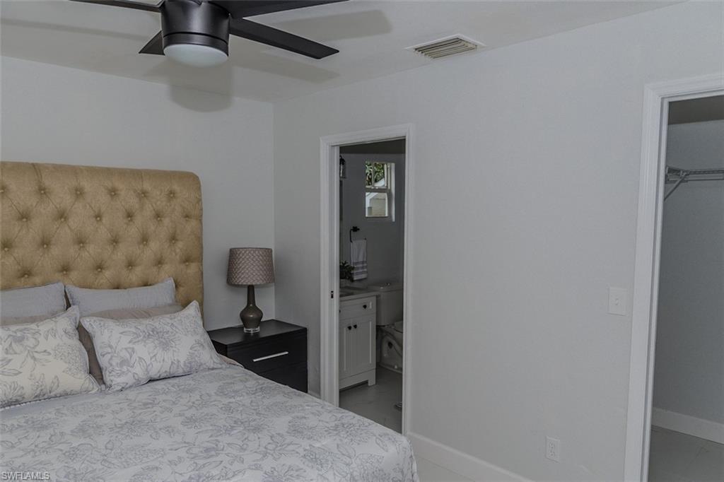 131 22nd Street Northeast Naples, FL 34120 - Photo 19 of 34 a bedroom with a bed and a television