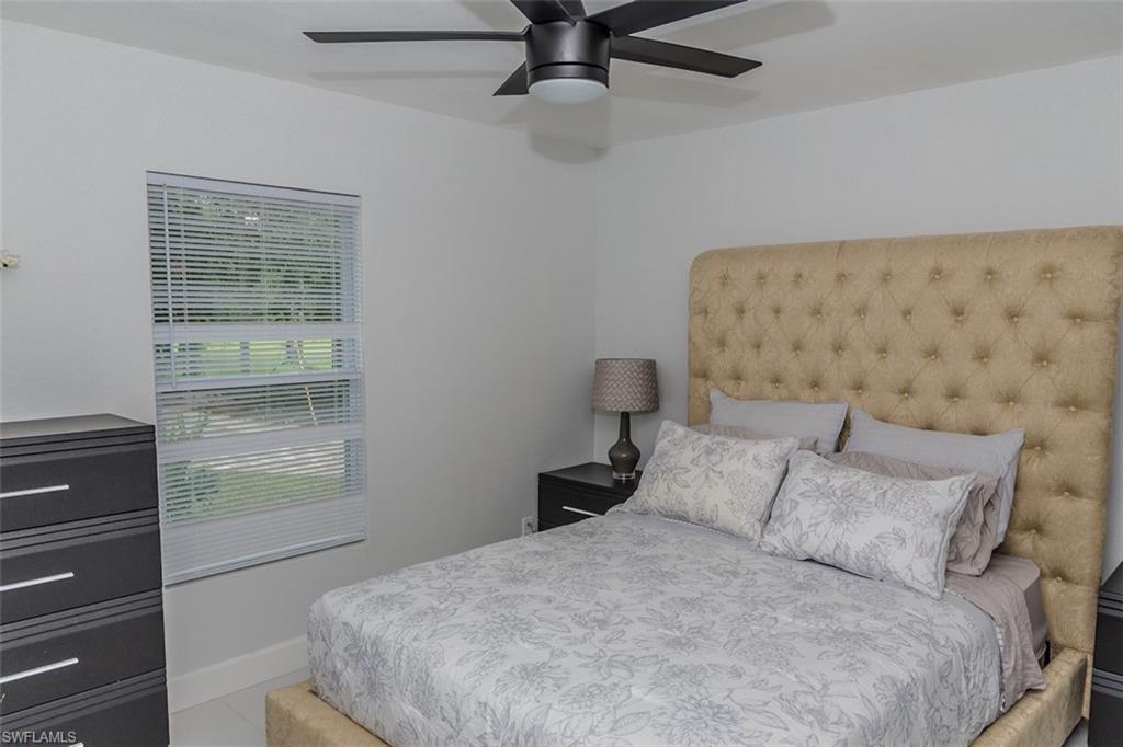 131 22nd Street Northeast Naples, FL 34120 - Photo 20 of 34 a bedroom with a bed and a window