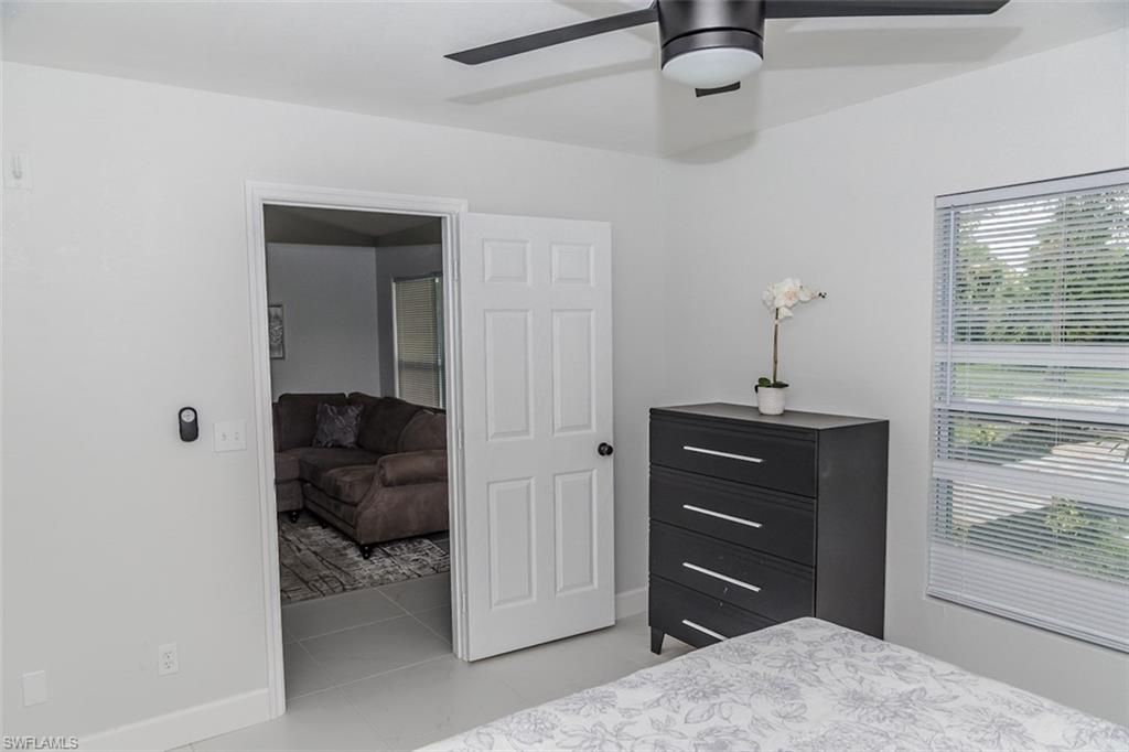 131 22nd Street Northeast Naples, FL 34120 - Photo 21 of 34 a bedroom with a bed and a dresser
