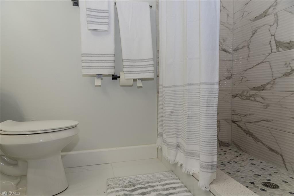131 22nd Street Northeast Naples, FL 34120 - Photo 23 of 34 a bathroom with a toilet and a shower