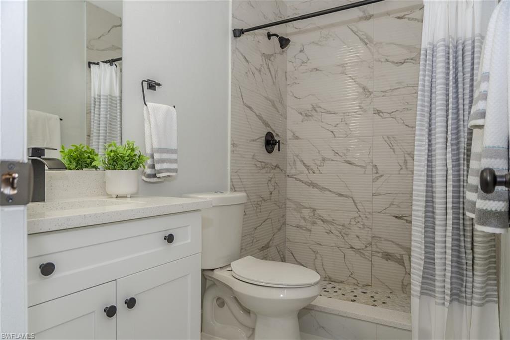 131 22nd Street Northeast Naples, FL 34120 - Photo 28 of 34 a bathroom with a sink a toilet and shower