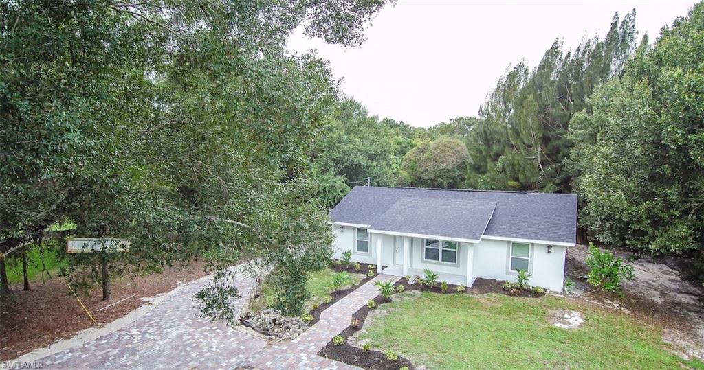 131 22nd Street Northeast Naples, FL 34120 - Photo 3 of 34 a view of a yard in front of a house