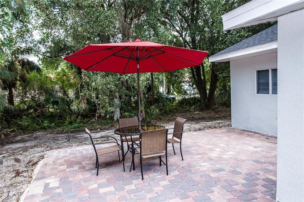 131 22nd Street Northeast Naples, FL 34120 - Photo 32 of 34 a view of a backyard with a patio and outdoor seating