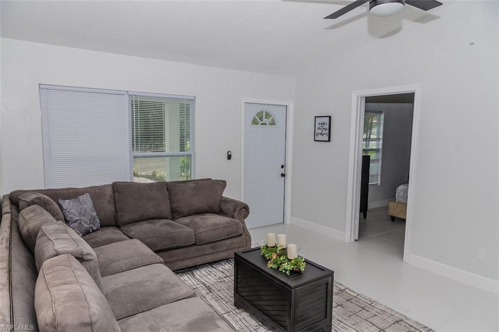 131 22nd Street Northeast Naples, FL 34120 - Photo 7 of 34 a living room with furniture and a potted plant