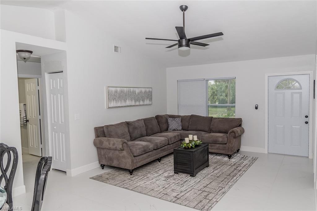 131 22nd Street Northeast Naples, FL 34120 - Photo 9 of 34 a living room with furniture and a rug