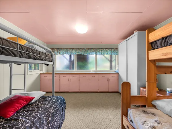 a bedroom with a bed and large window