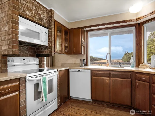 a kitchen with a stove a sink and a microwave