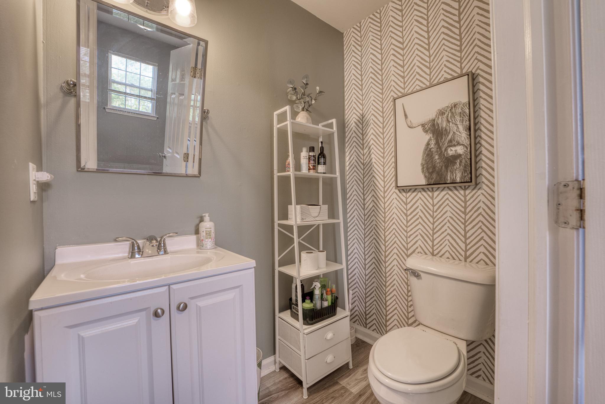 124 Vincent Circle Middletown, DE 19709 - Photo 14 of 19 a white toilet sitting next to a bathroom sink