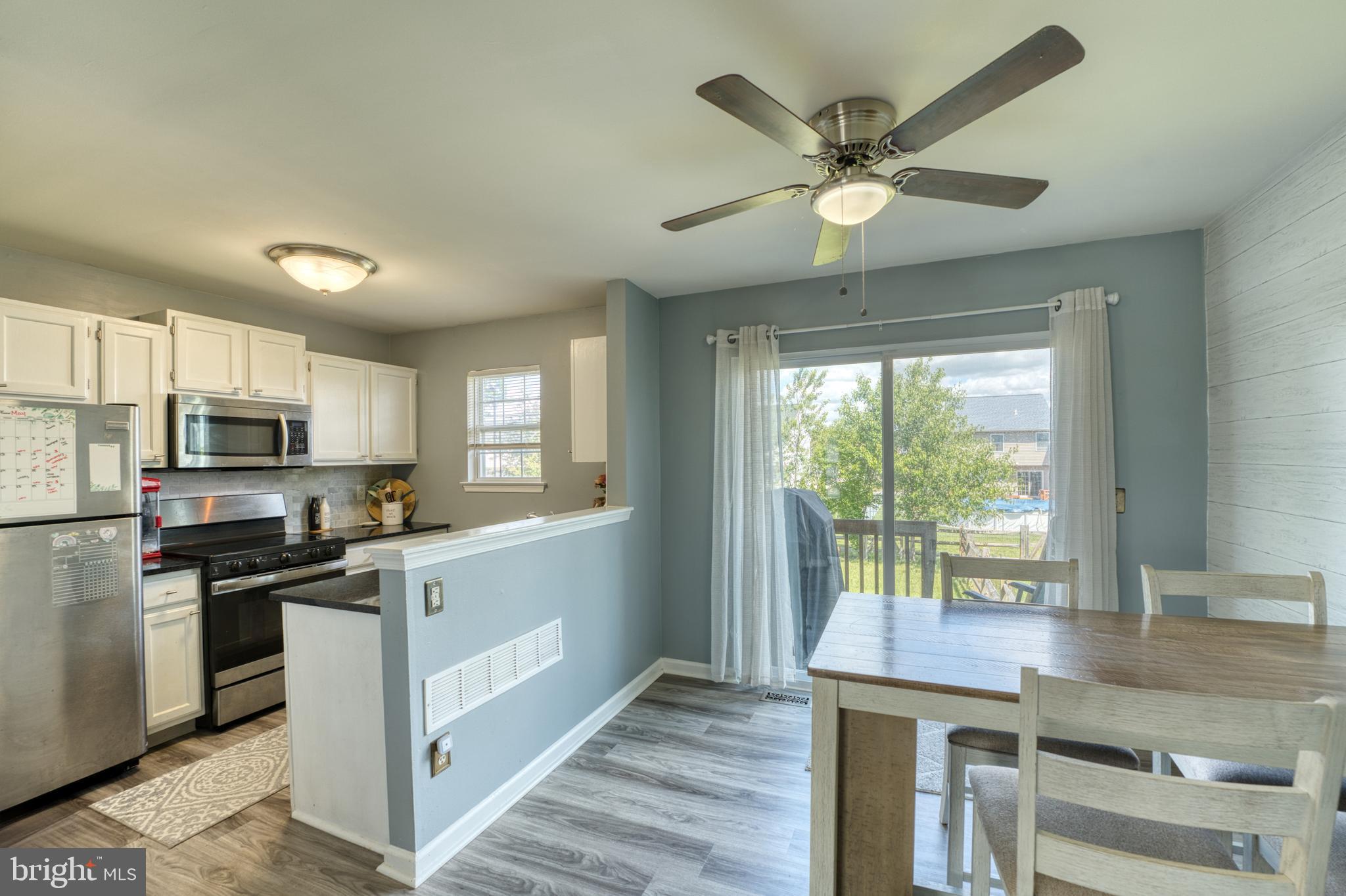 124 Vincent Circle Middletown, DE 19709 - Photo 5 of 19 a kitchen with stainless steel appliances white cabinets and wooden floor