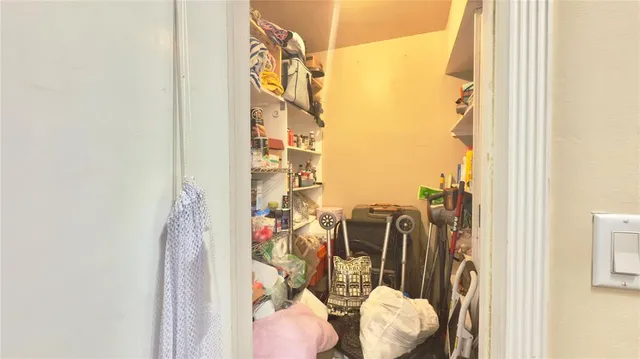 a view of walk in closet with clothes
