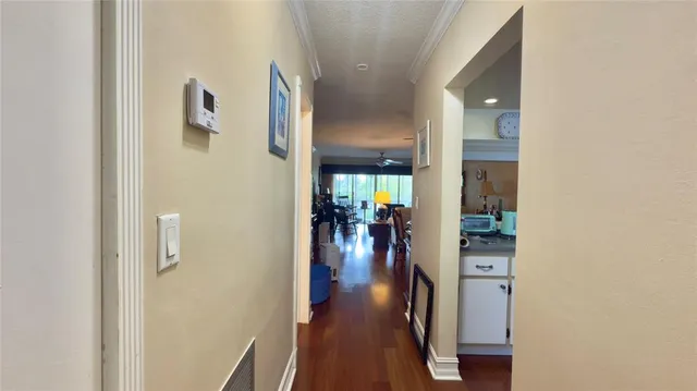 a view of a hallway with wooden floor