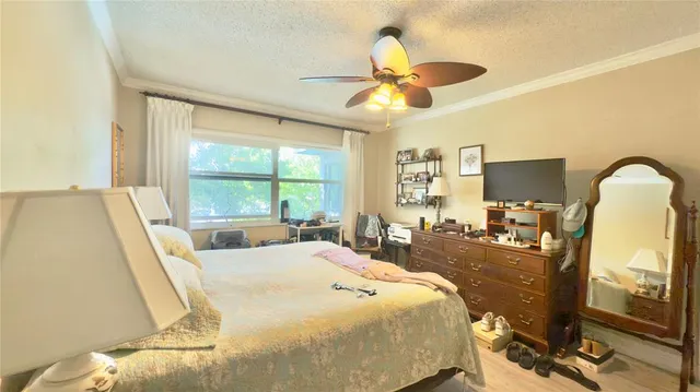 a bed room with a bed and a flat tv screen