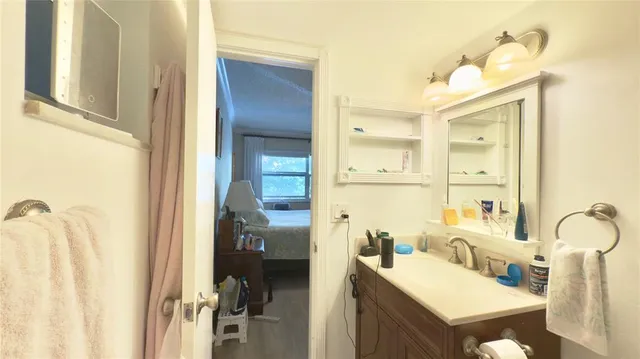 a bathroom with a sink mirror and a bathtub