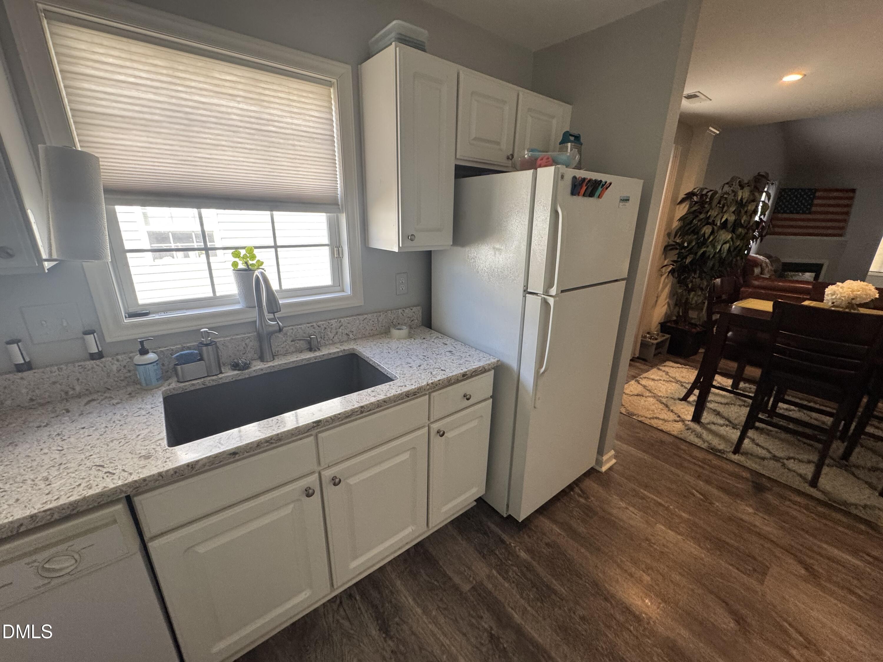 11351 Clubhaven Place, Unit 100 Raleigh, NC 27617 - Photo 9 of 29 a kitchen with a refrigerator a sink and a stove