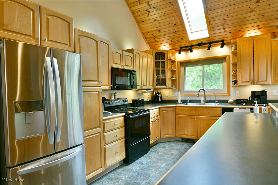 2907 Bushnell Campbell Road Fowler, OH 44418 - Photo 13 of 49 Kitchen with black appliances, open shelves, a sink, wooden ceiling, and rail lighting